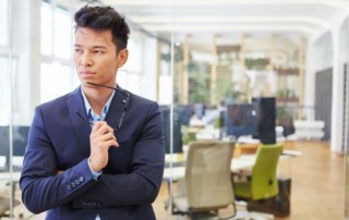Businessman in blue suit thinking