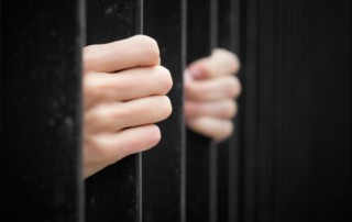 Jail - hands on bars