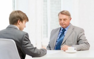 Older man signing papers