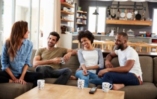 A group of four friends lounging on a coach