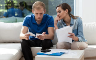 Young couple checking unpaid bills