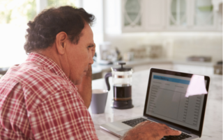 Concerned man reading email from debt collector