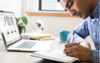 Young man taking notes in his notebook