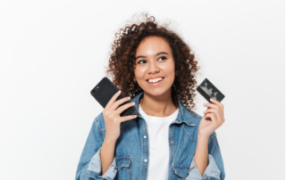 Woman smiling with a credit card in her hand