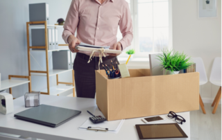 Man cleaning desk after being fired