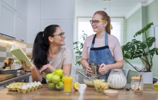 Mother and daughter cooking at home